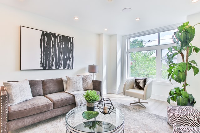 Modern interior living room showcasing natural stone flooring suitable for granite applications in UAE residential interiors, highlighting clean design, natural light, and contemporary finishes